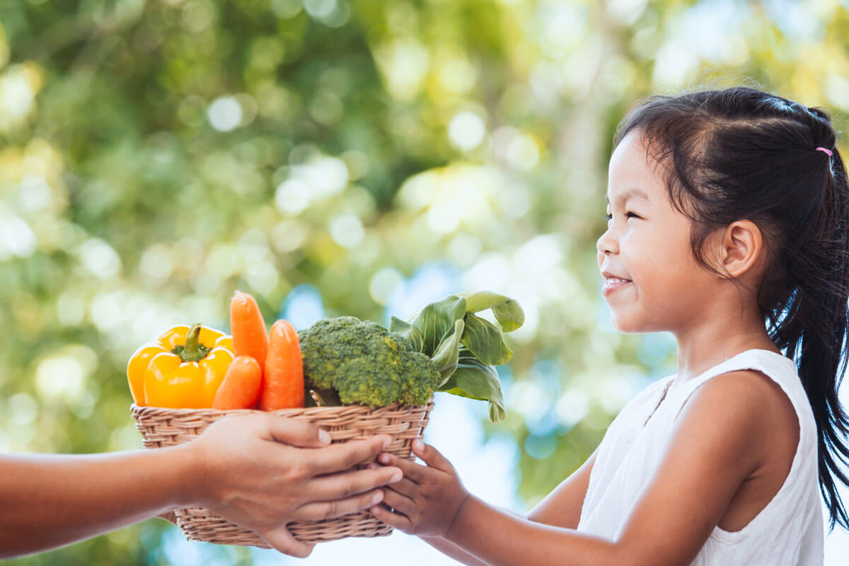 Child With Basket Of Vegetables